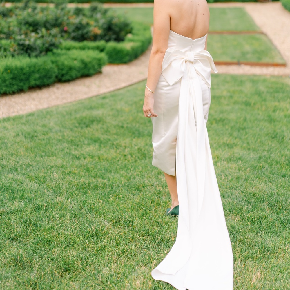 White reception dress with large bow train